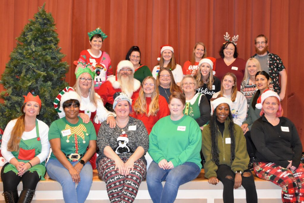 Therapeutic Foster Care staff gather together with Santa Claus for a holiday photo